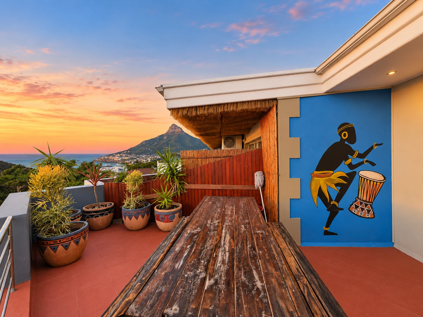 Communal terrace with a blue African mural and Lion’s Head