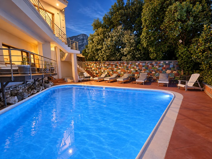 Blue-lit pool and mountain at twilight